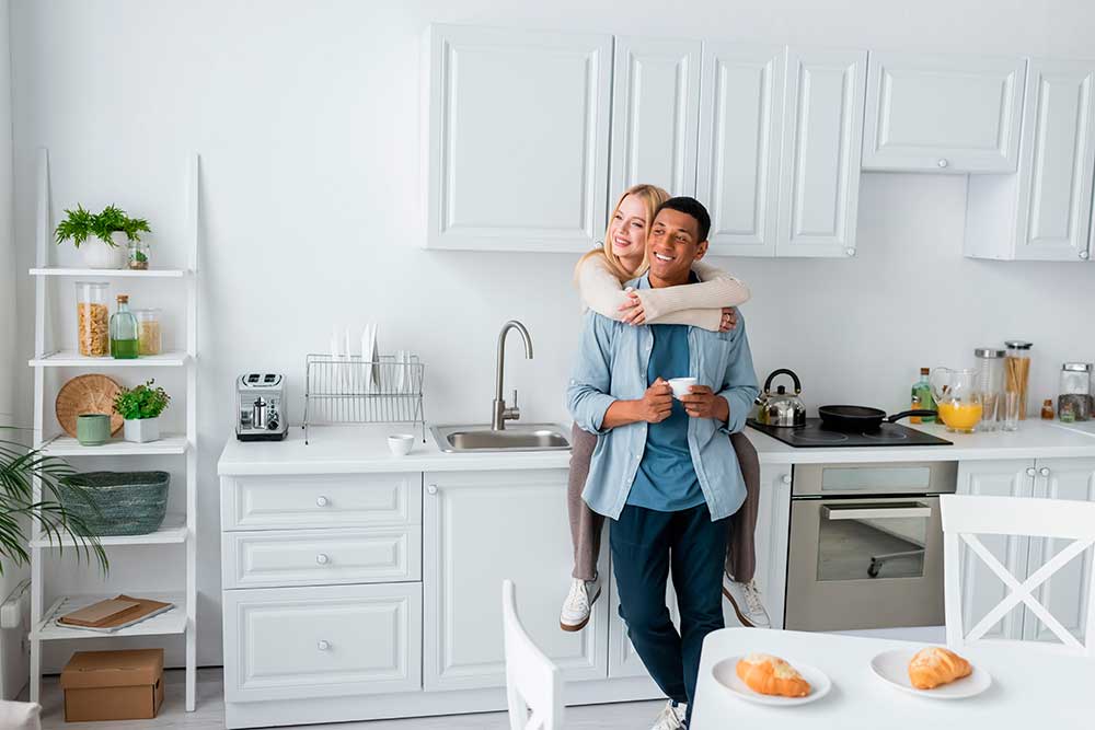 Man and woman hugging and happy in their newly remodeled kitchen