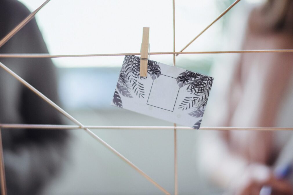 Photo with out-of-focus background and a notecard pinned to string in the foreground